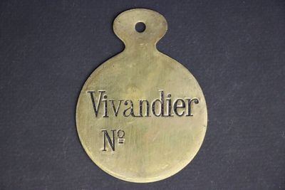 an old brass plate with the name of a woman on it