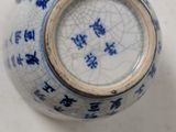 two blue and white vases sitting on a table