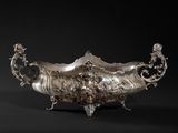 an antique silver plated bowl on a black background with a black background