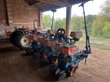 a tractor with a plow attached to it in a barn