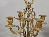 a gold colored candelab with five candles on it