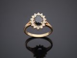 a gold ring with a black diamond and white diamonds