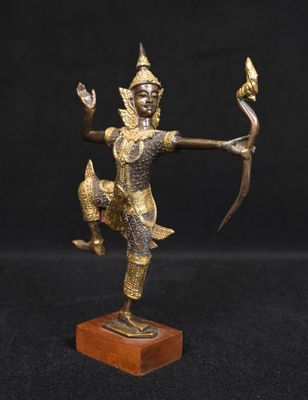 a bronze statue of a person holding a bow and arrow
