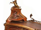 a wooden desk with a clock on top of it