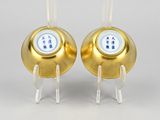 pair of gold and white buttons on clear acrylic bases