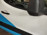 a small white car with a blue stripe on the side of it