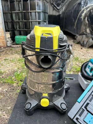 a vacuum that is sitting on the ground next to a laptop