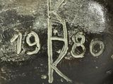 a close up of a metal object with writing on it