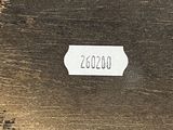 an old wooden box with a label on it sitting on top of a table