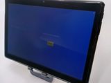 a tablet computer with a blue screen on a stand