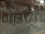 a close up of a vase with writing on it