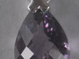 an amethorate and diamond pendant hangs from a silver chain