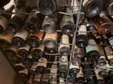 many bottles of wine that are stacked on a rack
