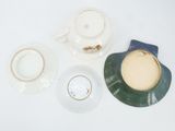 three cups and a saucer sitting on a table