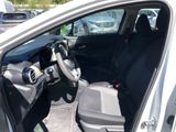 the interior of a car with the door open and the driver ' s seat down