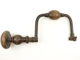 an image of a pair of antique wooden door handles on a white wall