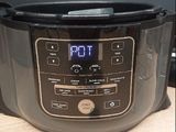 a close up of a digital pressure cooker on a table