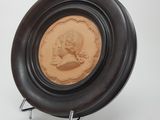 a brown plate with a picture of a woman on it