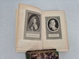 an open book with a picture of two men and a dog on it