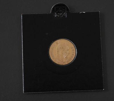 a close up of a coin on a black surface