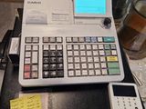 a calculator sitting on top of a table with notes on it