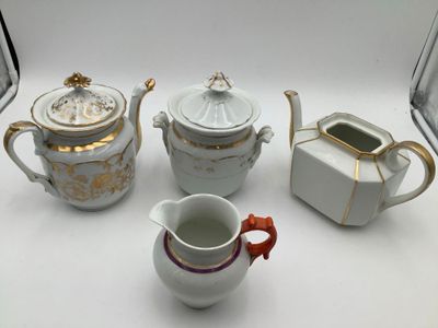 four different types of teapots on a white table