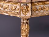 an image of a table with a marble top and gold decorations