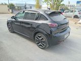 the rear end of a black car parked in a parking lot