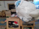 a large white stuffed animal sitting on top of a box