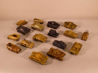 a lot of toy army vehicles on a white surface