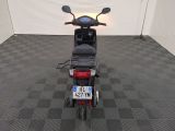 a motor scooter that is parked in a room