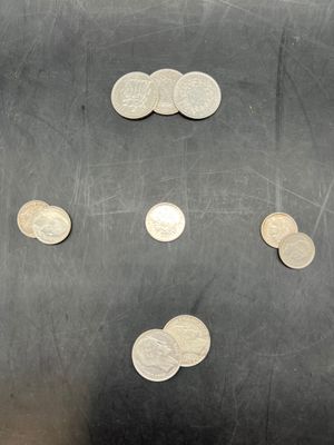 a lot of coins that are on the table