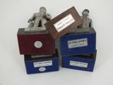three boxes with a statue of a man sitting on top of them