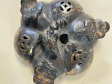 a metal object that looks like a face on a table