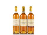 three bottles of wine sitting next to each other on a white surface