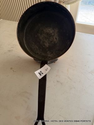 a black frying pan sitting on a counter with a price tag attached to it