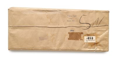 an old envelope with a stamp on it sitting on top of a white surface