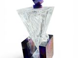 a glass bottle with a diamond on it on a white surface