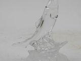 a glass figurine of a fish sitting on a plate