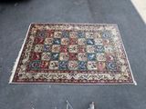 a rug on the floor next to a pair of scissors