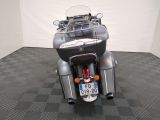a motorcycle that is parked in a room with a checkered floor