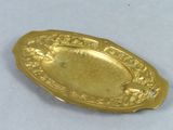 gold plate with a design of flowers and birds on it