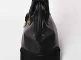 a black leather handbag on a white background