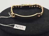 a close up of a ring on a black box with a tag