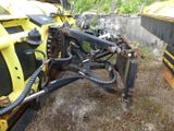 a yellow tractor that is parked in the grass