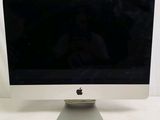 a computer monitor sitting on top of a white table