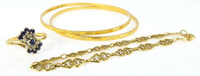 two gold bracelets, a ring, and a bracelet with a chain