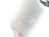 a close up of a silver vase with a black handle