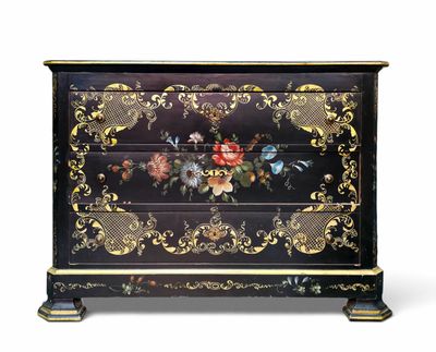 a chest of drawers with a floral design on the front