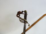 a close up of a sword with a handle on a table